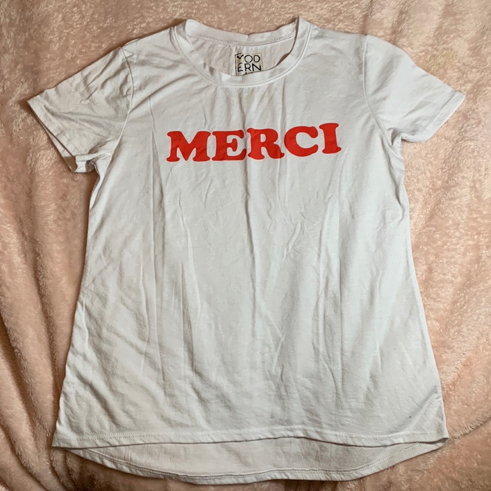 plain white T with “MERCI” across